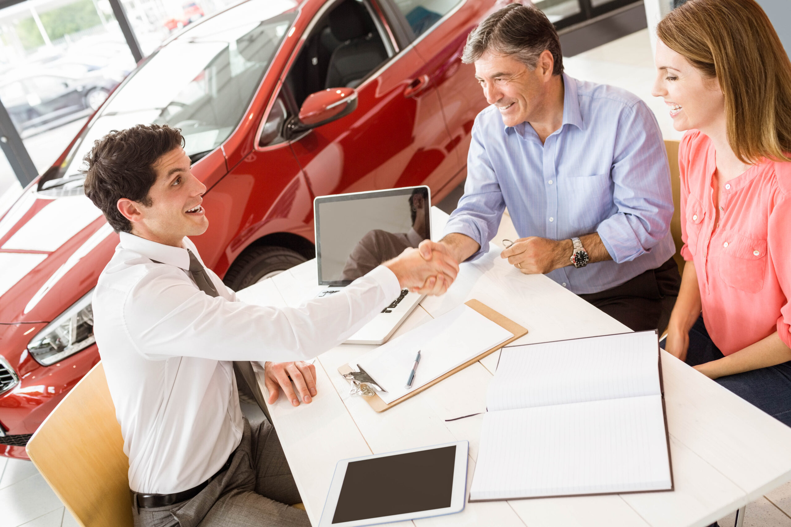 customers signing some important documents at new car showroom