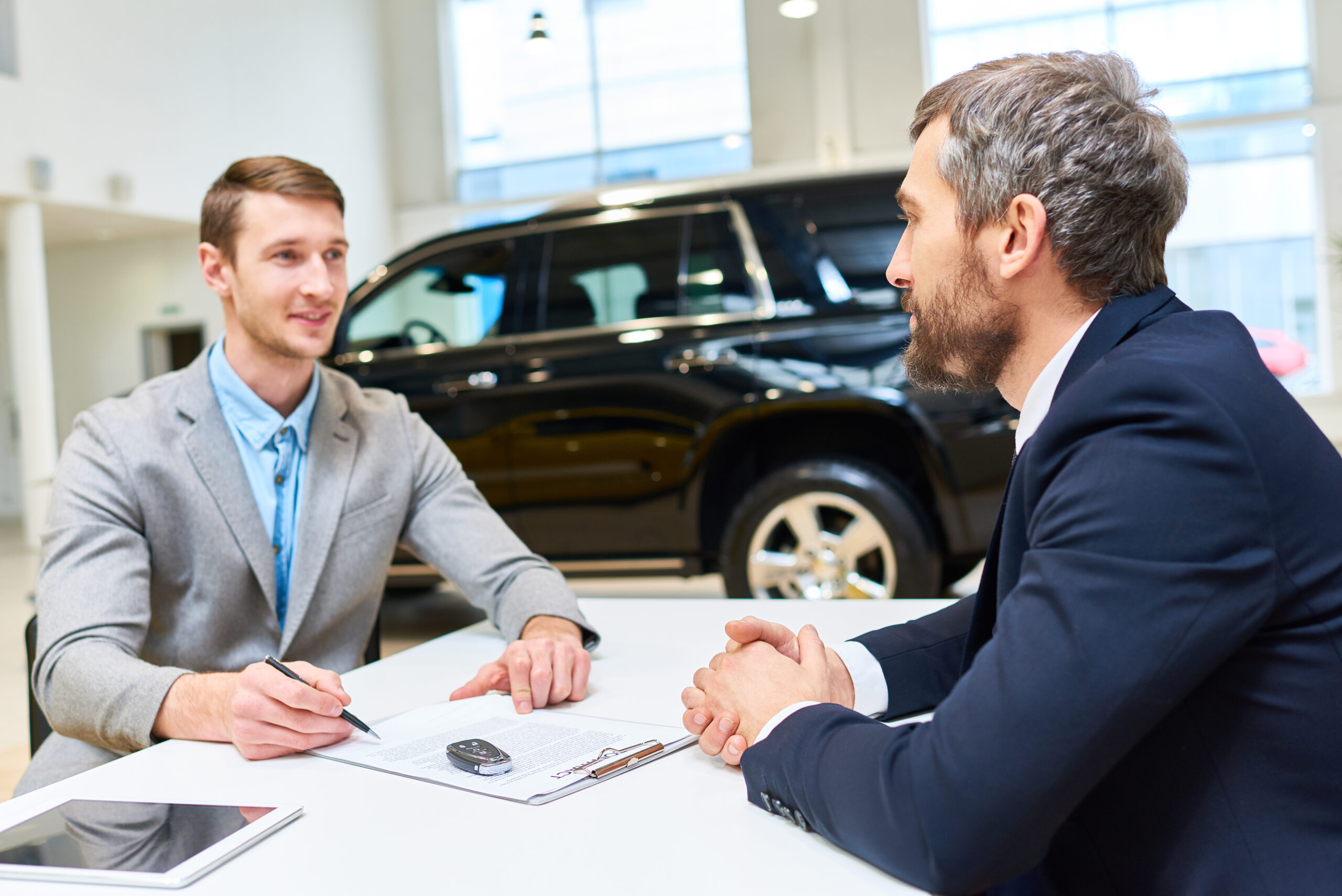 handsome young man buying luxury car